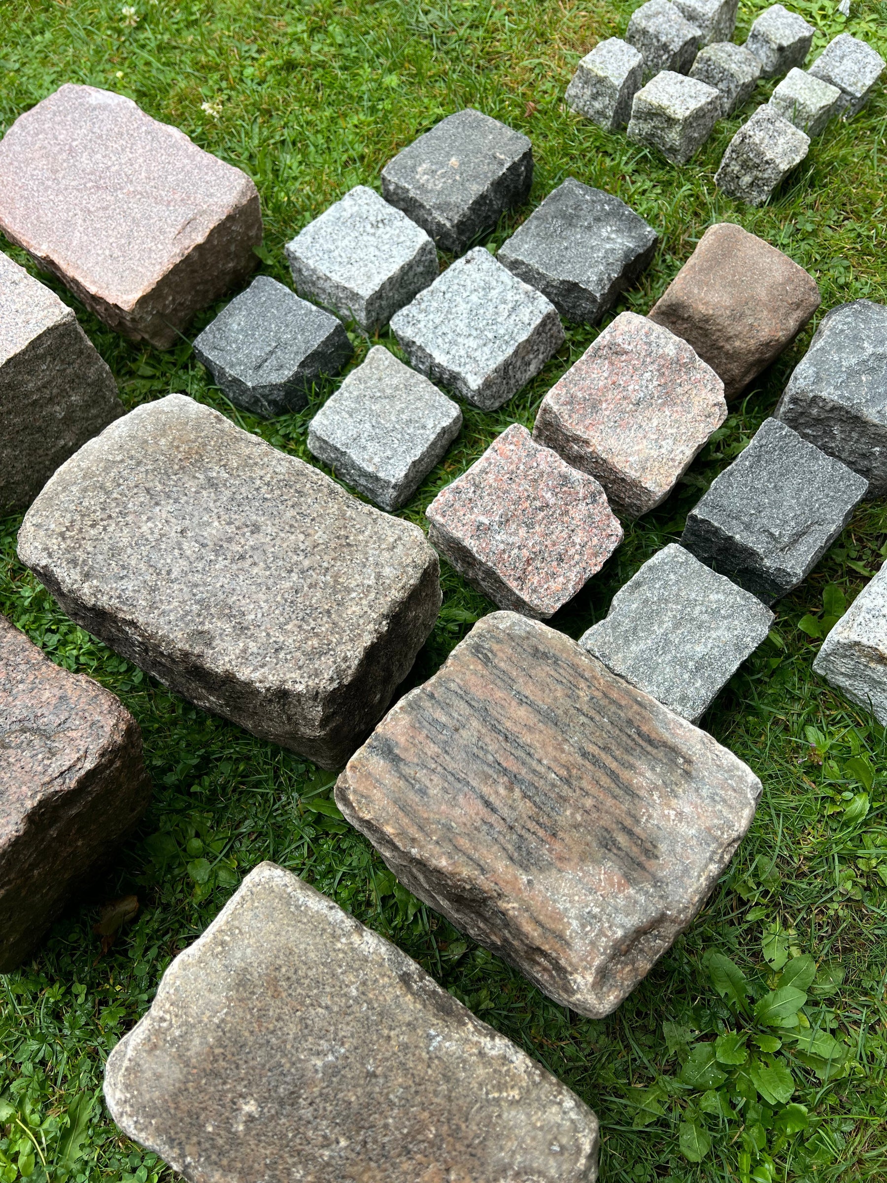 Granitsten til belægning: Chaussesten, brosten og mosaiksten på græs.